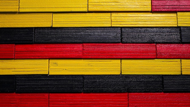 Photo abstract background of wooden bars in black red and yellow tones