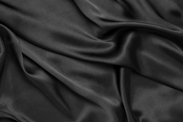 Abstract black background luxury cloth or liquid wave or wavy folds of grunge silk texture satin velvet material or luxurious