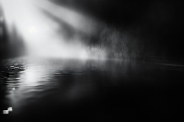 Abstract black and white background of foggy water surface at night