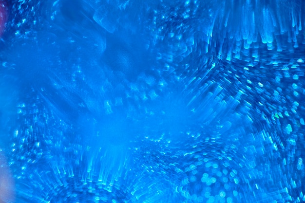 Abstract blue background with blurred shiny shapes