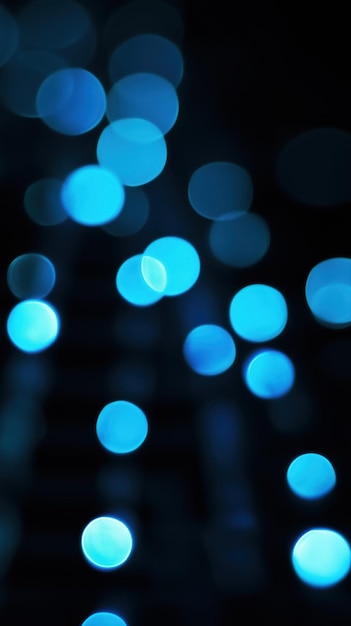 Photo abstract blue bokeh lights against a dark background creating a dreamy and ethereal atmosphere