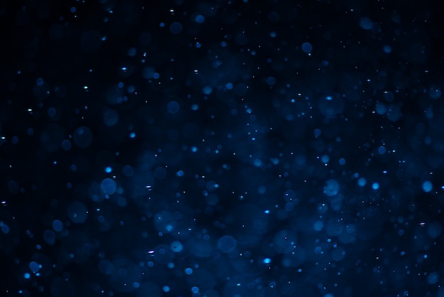 Abstract blue bokeh with black background.