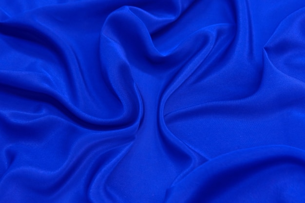 Abstract blue color silk chiffon fabric texture background.