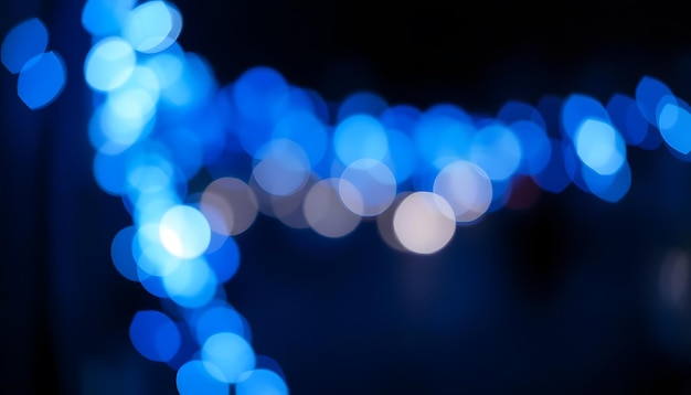 Photo abstract blue defocused bokeh of lights in dark isolated with white highlights