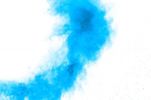 Abstract blue dust explosion on white background.Freeze motion of blue powder splash. 