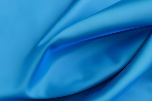 Abstract blue fabric background with smooth flowing lines