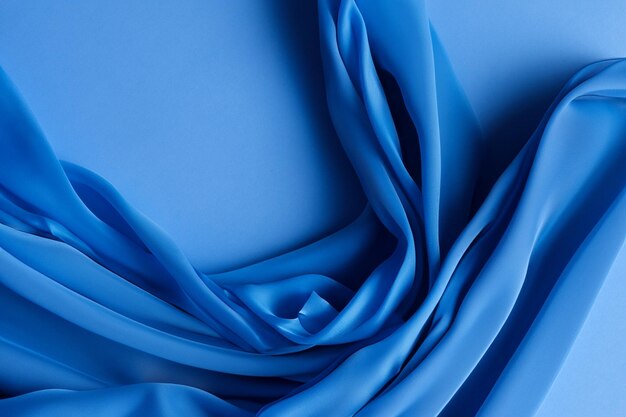 Abstract blue fabric background with soft folds and creases ideal for minimalist design concepts