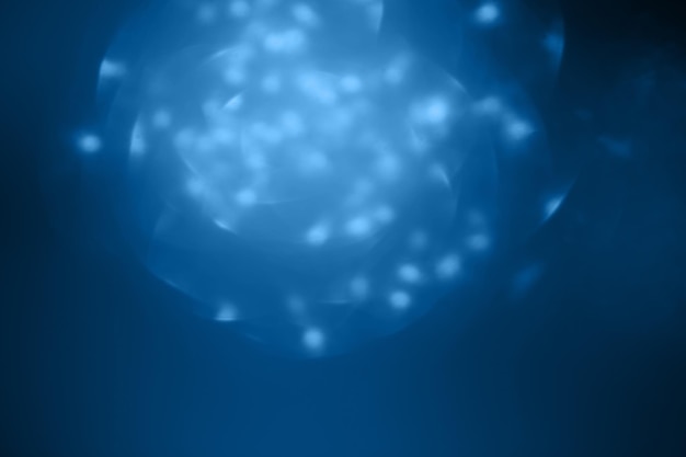 Abstract blue glowing background with bokeh out of focus