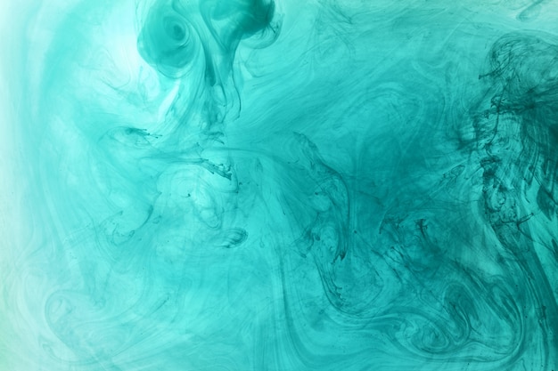 Abstract blue-green ocean, paint in water background. swirl of splashes and waves in motion. Fluid art wallpaper, liquid vibrant colors