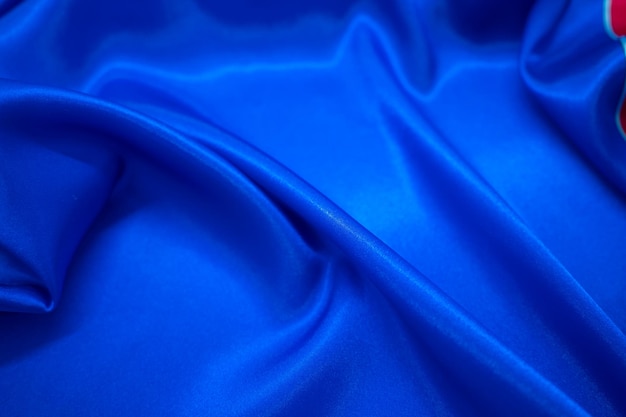 Abstract blue Satin Silky Cloth Fabric Textile Drape with Crease Wavy Folds background