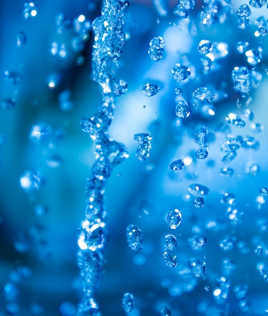 Abstract blue water background Falling water drops Macro photo