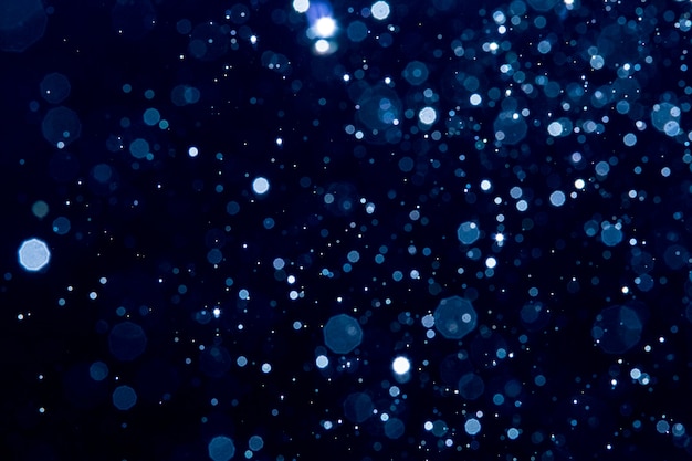 Abstract blur blue sparkle bokeh with black background