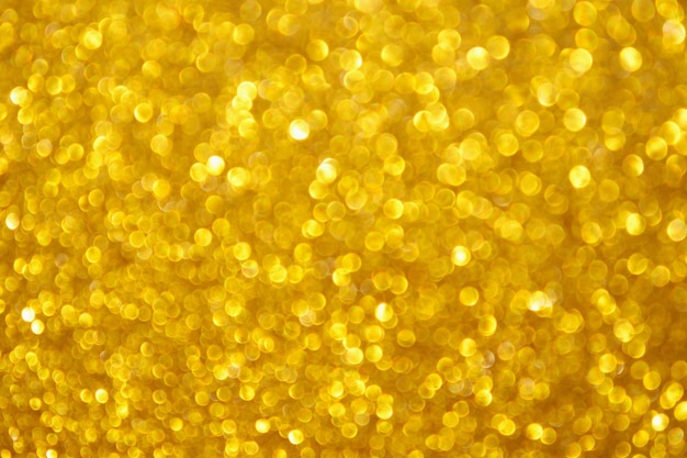 Abstract blur gold glitter sparkle defocused bokeh light background