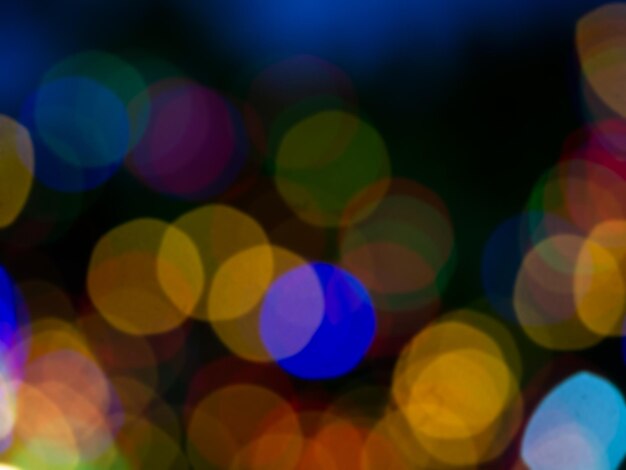 Abstract blur image of colorful light of night party bokeh on dark background Blurred festive and celebration bokeh background Blurry festival light