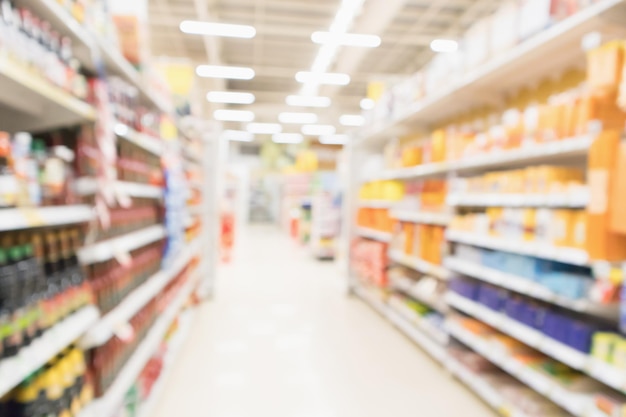 Abstract blur supermarket discount store aisle and product shelves interior defocused background