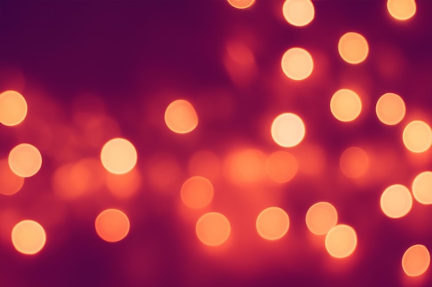 Abstract blur of warm orange lights on a crimson background