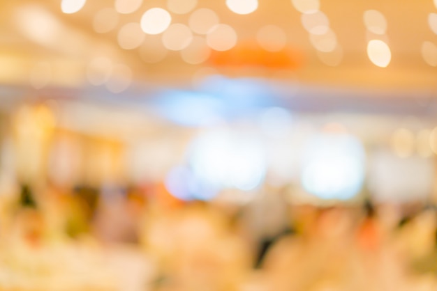 Abstract blur of wedding party in large hall 