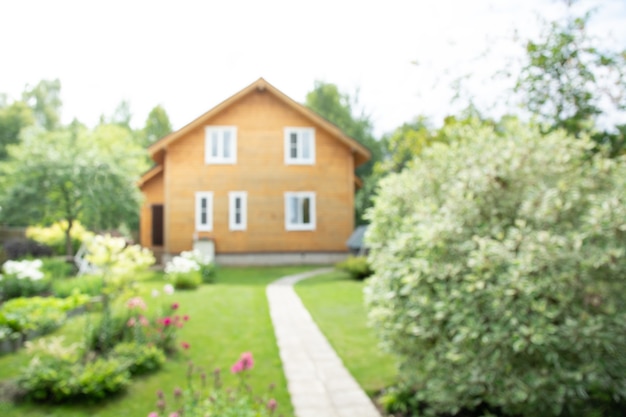 Abstract blurred background of wooden house in village for usage in sale of building materials