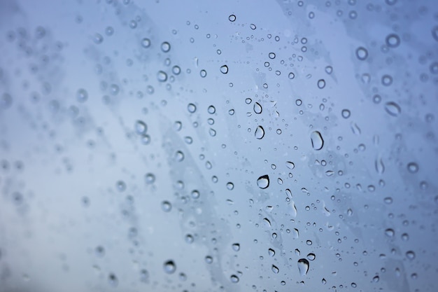 Abstract blurred Rain while the car is in the middle of the road at night Car tail light 