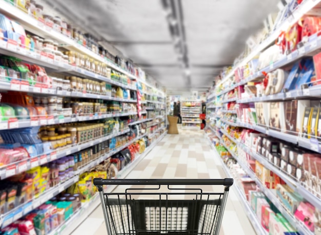 Abstract blurred supermarket choosing a dairy products at supermarket empty grocery cart