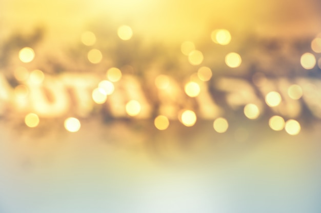 Abstract blurred yellow bokeh lights in golden festive decoration