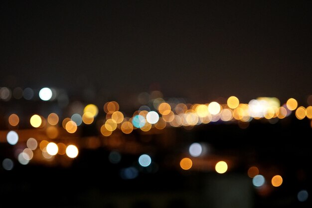 Abstract blurry city glitter lights at night background