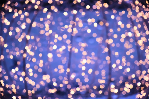 Abstract Christmas background, burning lights of garlands, blurred bokeh.