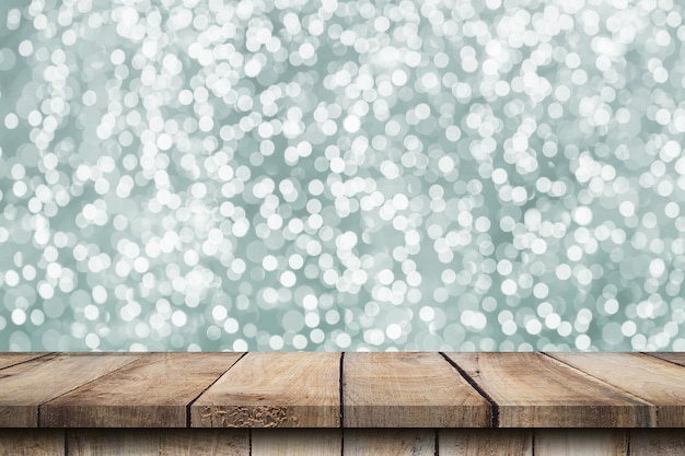 Abstract circular boken nigth and wood table for christmas background with space