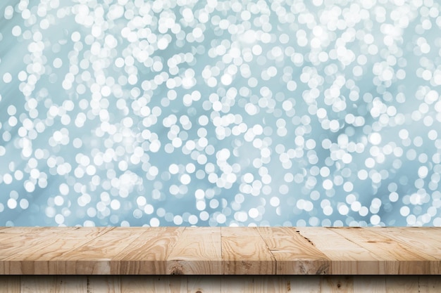 Abstract circular boken nigth and wood table for christmas background with space