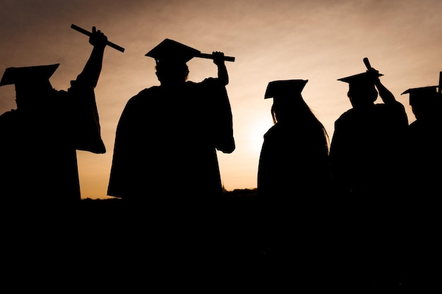 Abstract Close up Rear view group of the university graduates at Silhouette sunset