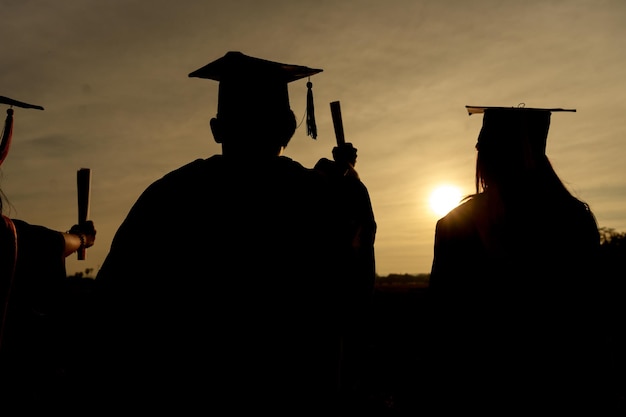 Abstract Close up Rear view group of the university graduates at Silhouette sunset