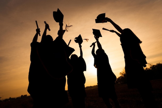 Abstract Close up Rear view group of the university graduates at Silhouette sunset