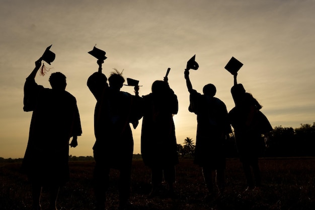 Abstract Close up Rear view group of the university graduates at Silhouette sunset