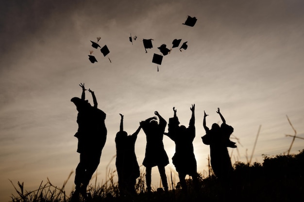 Abstract Close up Rear view group of the university graduates at Silhouette sunset