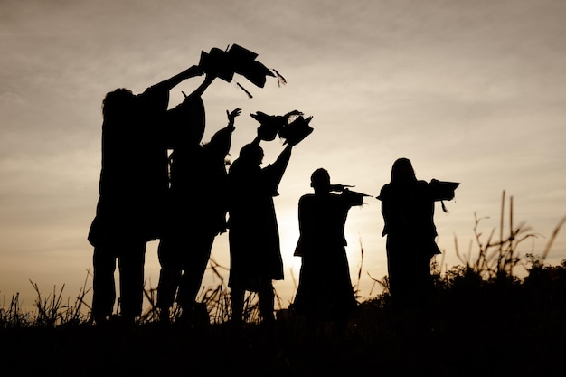 Abstract Close up Rear view group of the university graduates at Silhouette sunset