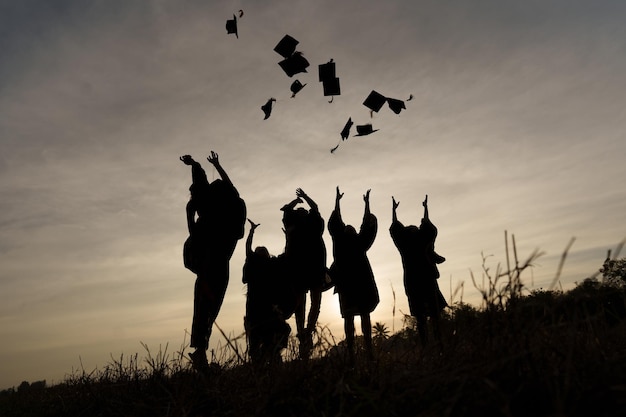 Abstract Close up Rear view group of the university graduates at Silhouette sunset