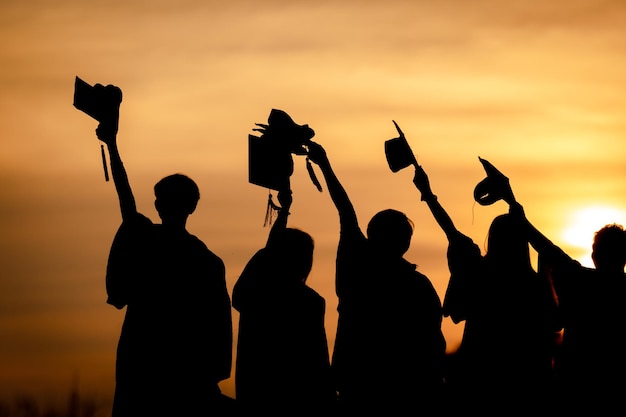 Abstract Close up Rear view group of the university graduates at Silhouette sunset