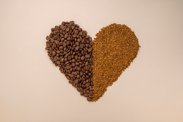 Abstract coffee concept Ground instant coffee and coffee beans in heart shape on warm neutral background