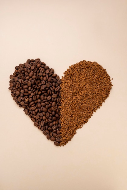 Abstract coffee concept Ground instant coffee and coffee beans in heart shape on warm neutral background