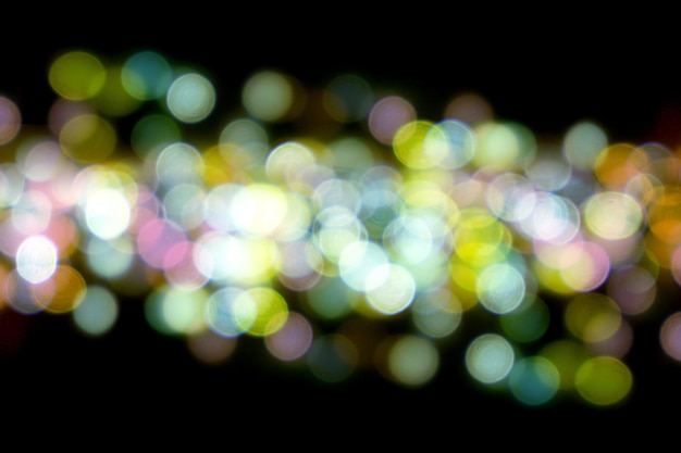 Abstract colorful bokeh and blurred reflection lighting on black background