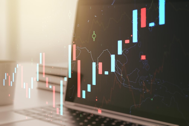 Abstract creative financial graph on modern laptop background forex and investment concept Multiexposure