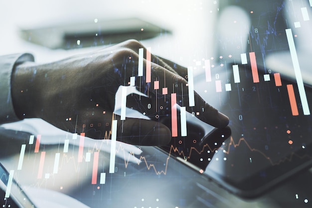 Abstract creative financial graph with finger clicks on a digital tablet on background financial and trading concept Multiexposure