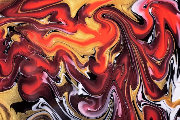 Abstract fluid art background dark red and golden colors. Liquid marble. Acrylic painting on canvas with orange lines and gradient. Alcohol ink backdrop with black wavy pattern.