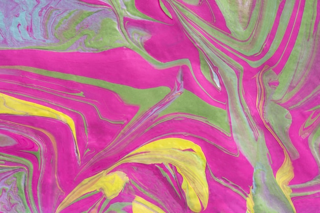 Abstract fluid art texture. A multicolored pictorial fragment of a painting. Bright acrylic drawing of pink, yellow, purple, pale green and blue shades close-up. The concept of summer mood, flowering