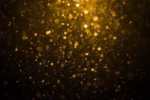 Abstract gold bokeh with black background