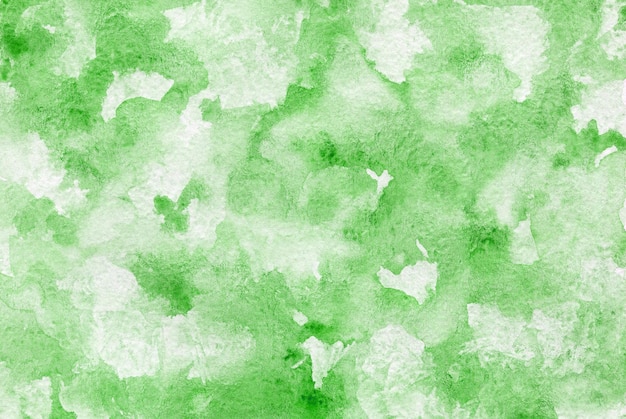 Abstract green watercolor background hand painted backdrop on textured paper