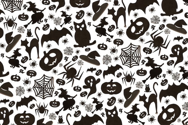 Abstract halloween pattern in cartoon style on white background. Paper art. Happy hallowen holiday concept.