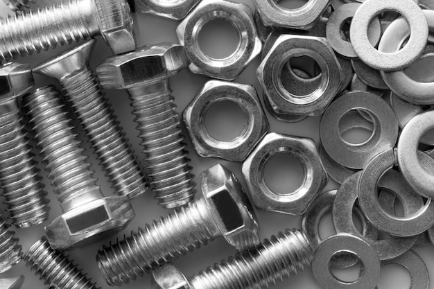 Abstract industrial textured metal background  with many metal nuts and bolts