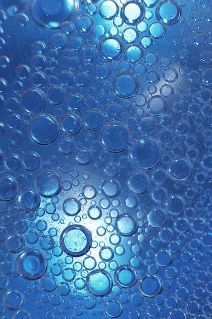 Abstract light blue background with oil circles  bubbles of water close up