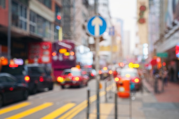 Abstract light blurred car transport with road signs in the street at Hongkong